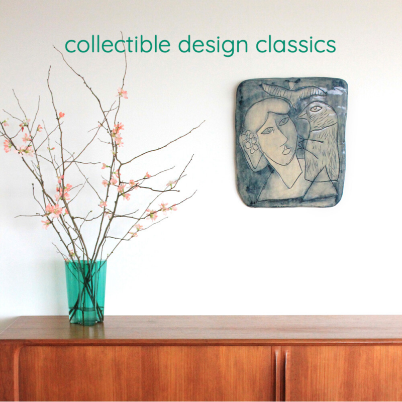 Mood picture with a teak sideboard by Bernhard-Pedersen. On the sideboard, an emerald green Savoy vase by Alvar Aalto. On the wall, an azure blue ceramic plate by Corneille.