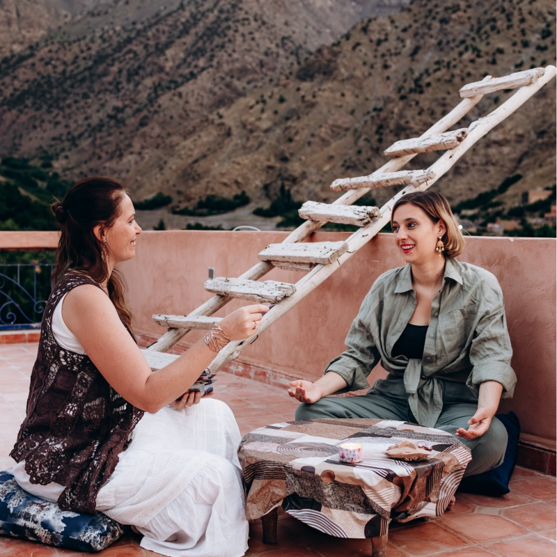 Yin Yoga Retreat Marrakech women practicing mindfulness, reflection and connection during a rooftop ceremony in Morocco