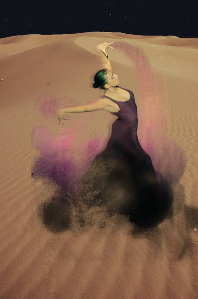 Woman dancing flamenco in the Sahara Desert at sunset in Morocco