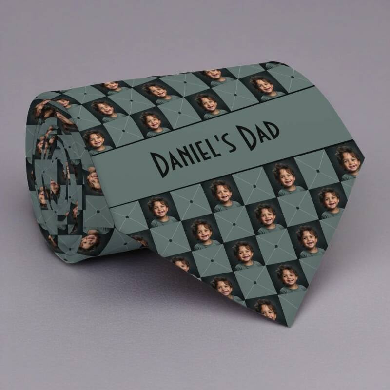 Moss green custom photo pattern necktie featuring single child photo repeated in a checkerboard pattern. Necktie can be personalized with custom text in a band across the bottom of the tie.