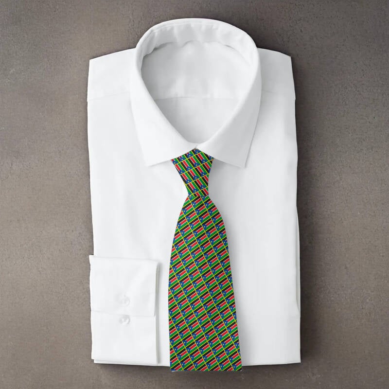 South Sudan flag necktie on folded white shirt