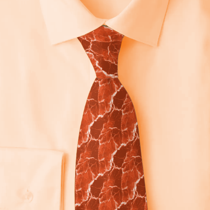 Marble terracotta necktie on a folded cream colored shirt