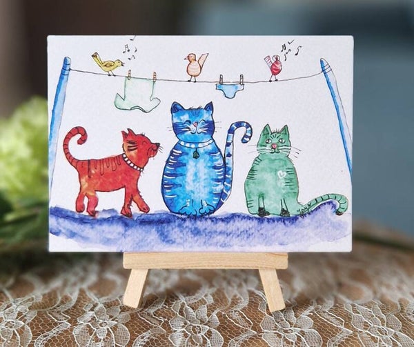 Katten bij de waslijn