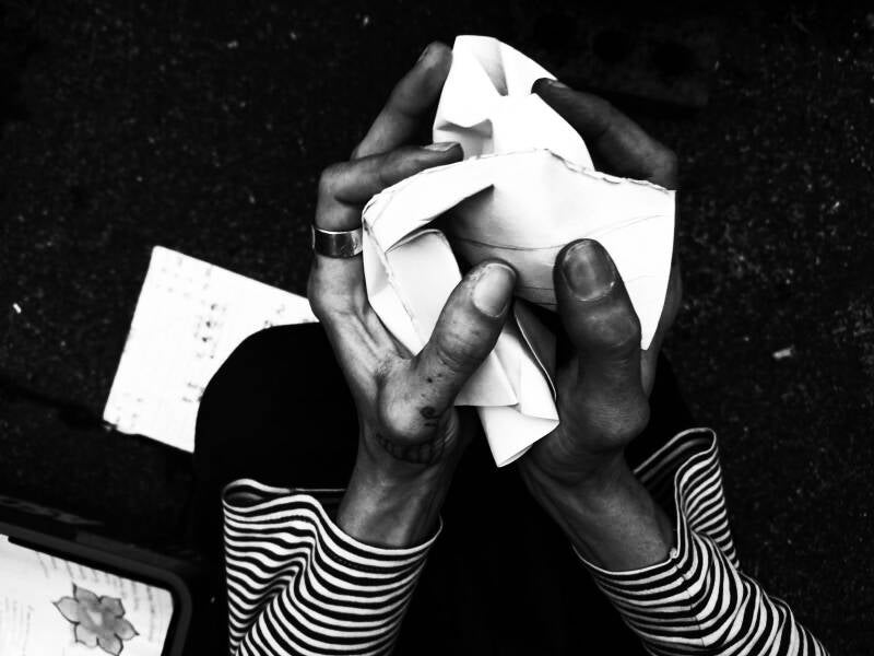 Hands crumple paper 
