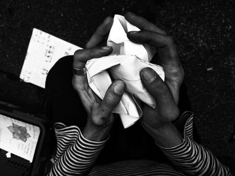 Hands crumple paper 