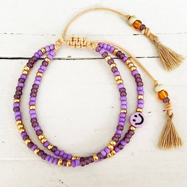 Armbandje paars-goud met kwastjes