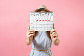 lady holding calendar for tracking periods