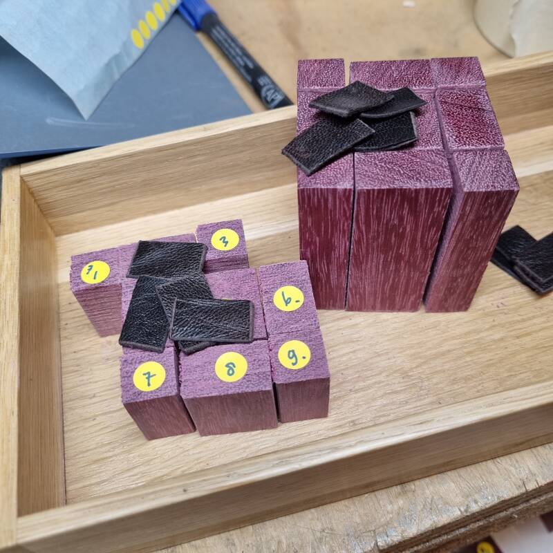 pieces of recycled leather cut to size with the blocks of purpleheart wood for the candlestick