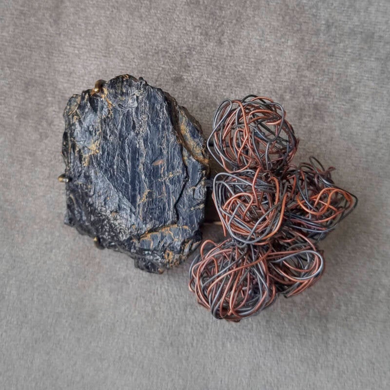 Award-winning brooch featuring copper and iron wire, representing my coal miner grandfather and disciplined grandmother, with six metal balls symbolising their children.