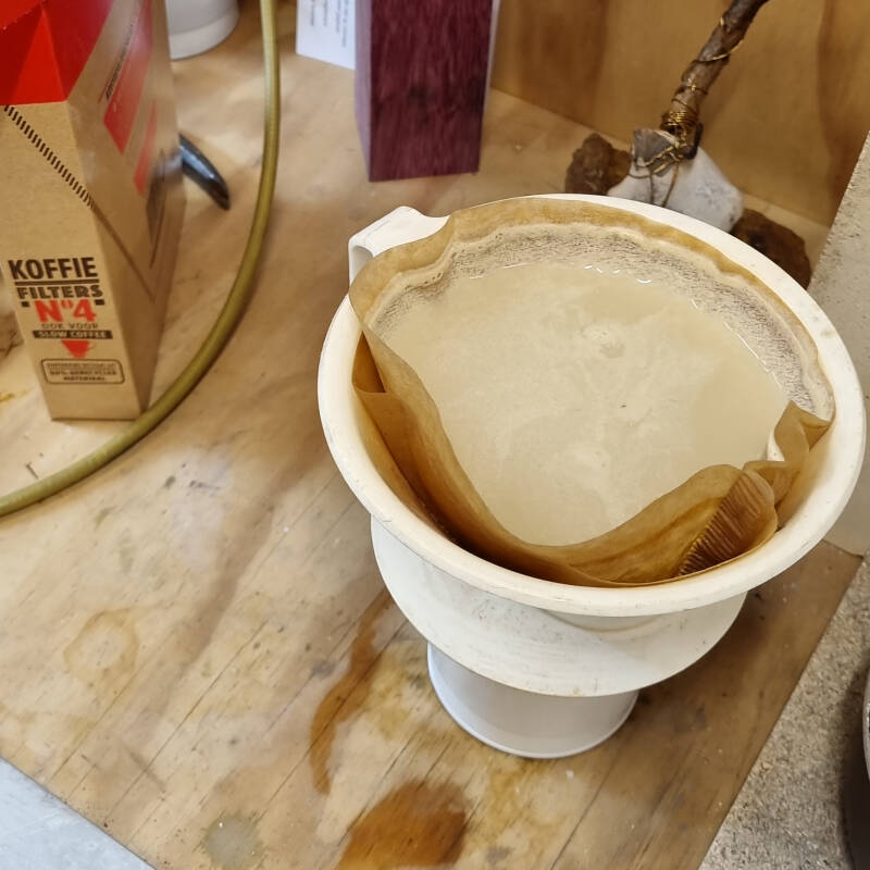 coffee filter containing marl pigment that is still wet