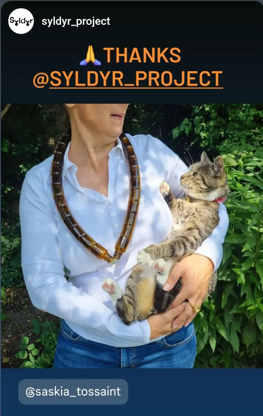 my necklace made out of 28 glass bottles that contained Interferon worn by me while holding our FIV cat Shadow