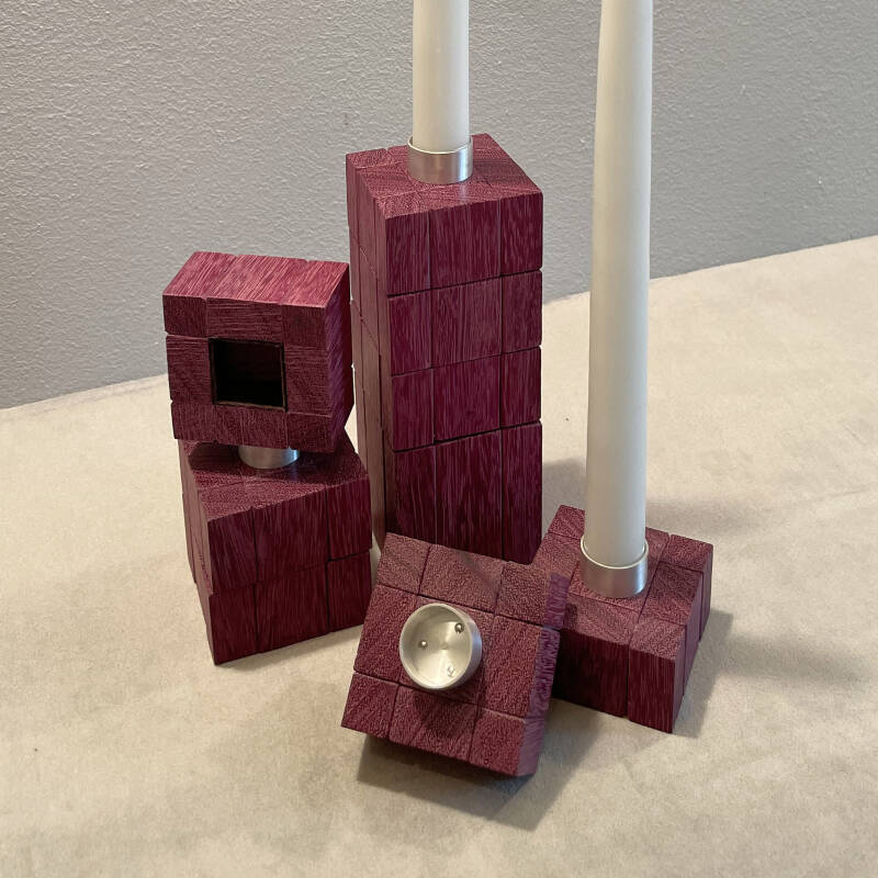 overview of the bottom and inside of the Argentium silver candle holder together with stacked candlesticks