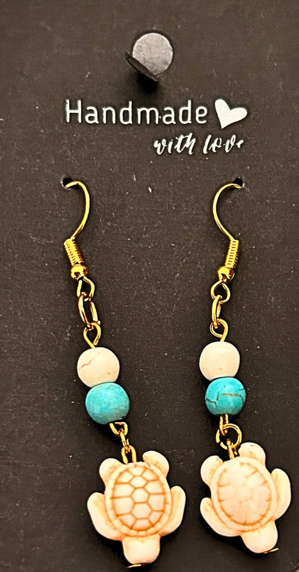 Gold-plated blue and white earrings with a white turtle charms