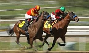 Two jockeys compete in a neck-and-neck horse race