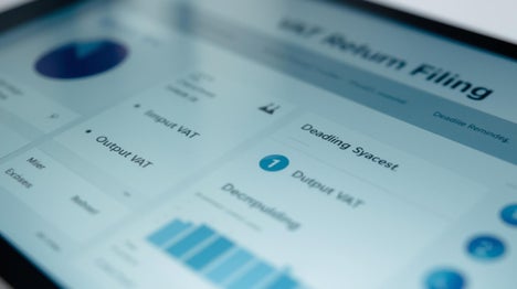Digital dashboard on a tablet displaying VAT Return Filing Process summary.