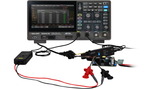 An SDS824X HD running Power Analysis, with a differential voltage probe and a current probe connected to a switch-mode power supply board