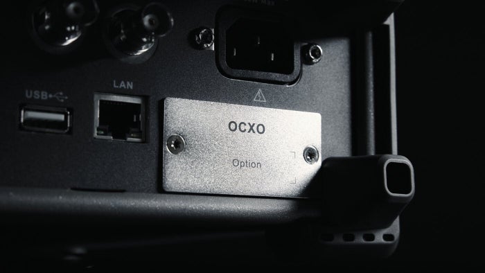 The OCXO option bay on the rear panel of the SSG3000X Plus, beside the USB and LAN ports