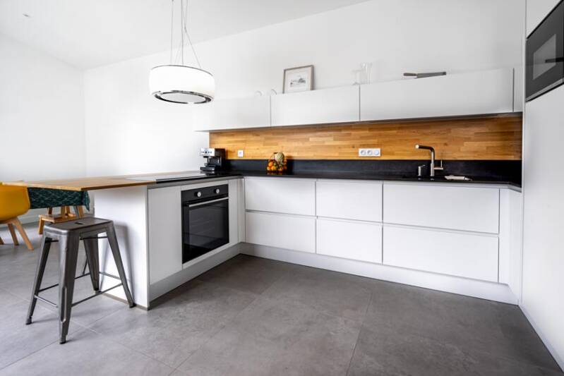 Modern white kitchen with wood accents