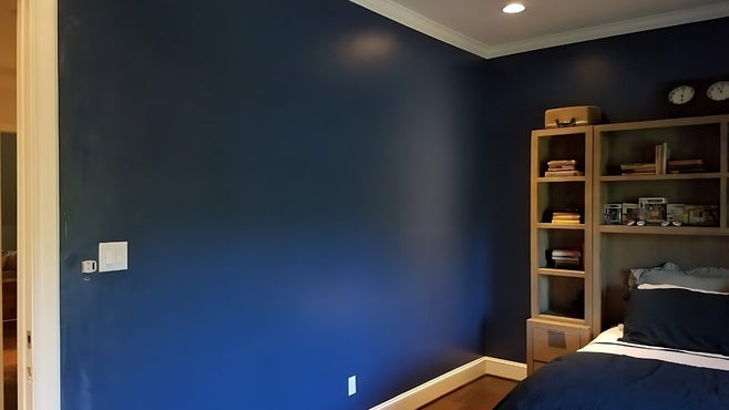 deep blue walls, natural wood colored cabinets over bed headboard painted by house painting triforce in dallas tx