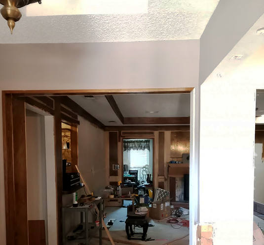 before living room renovation in garland, wood panels removed, ceiling and walls skim coated