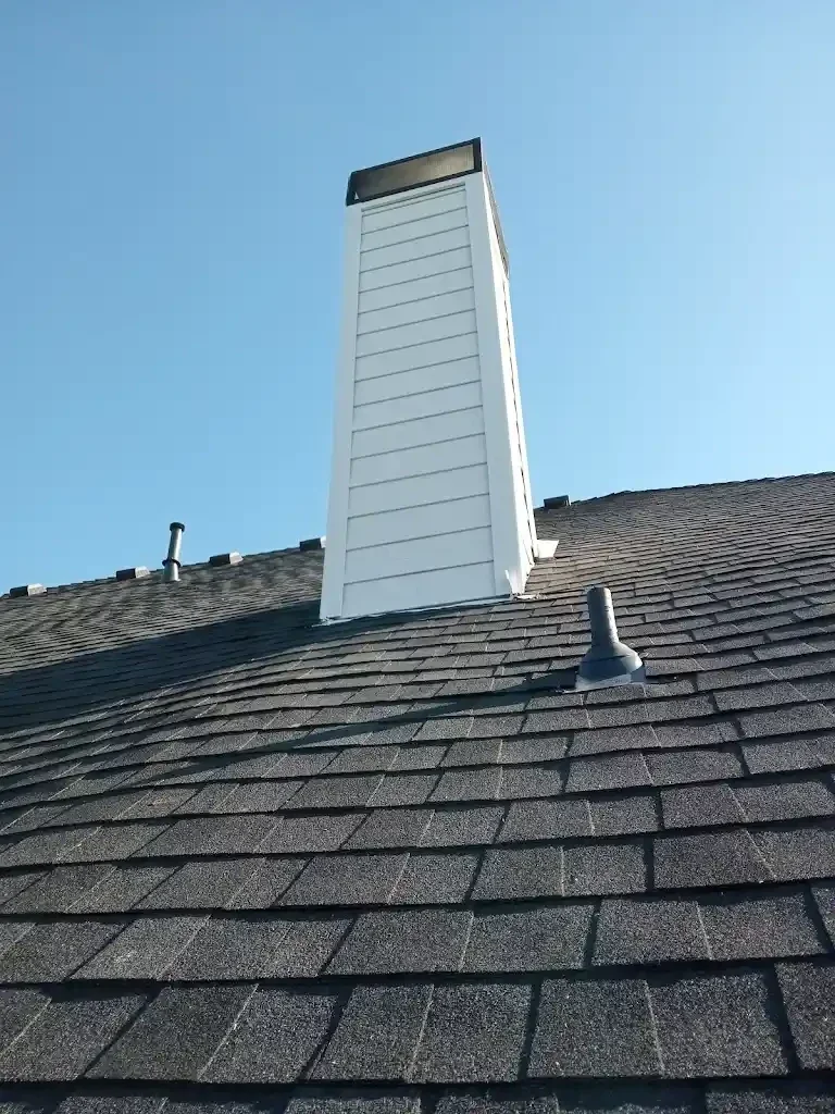 weathered chimniey siiding got a refresh new smartboard siding insttalled and painted in white