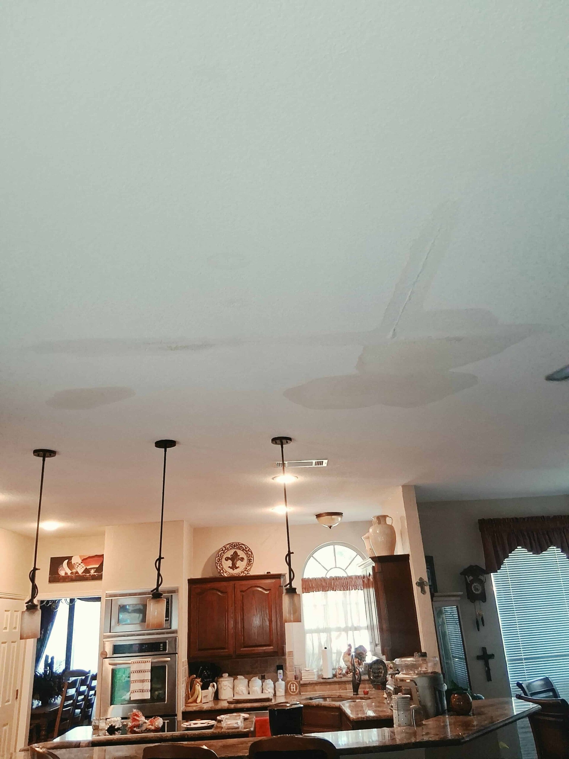 water damaged ceiling in living room before work done 