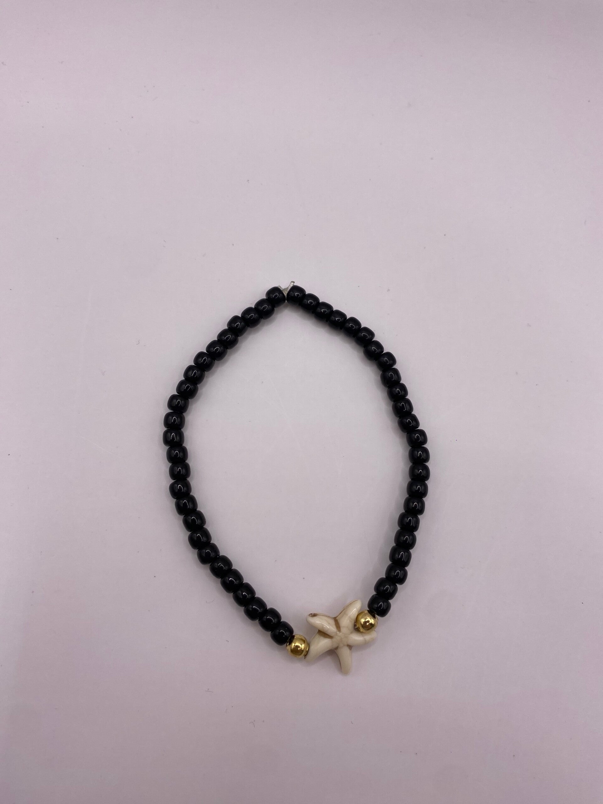 Zwart armbandje met zeester