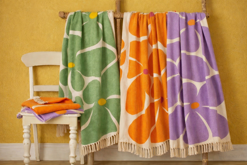 Colourful floral throws in green, orange and purple