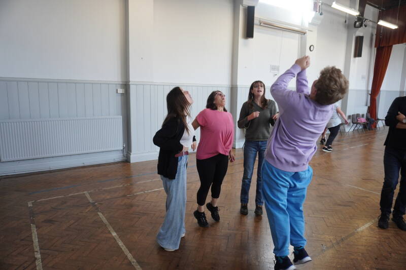 An image showing a group of people taking part in Ottery Community theatre's workshop on acting, this image shows [people pulling on an imaginery rope