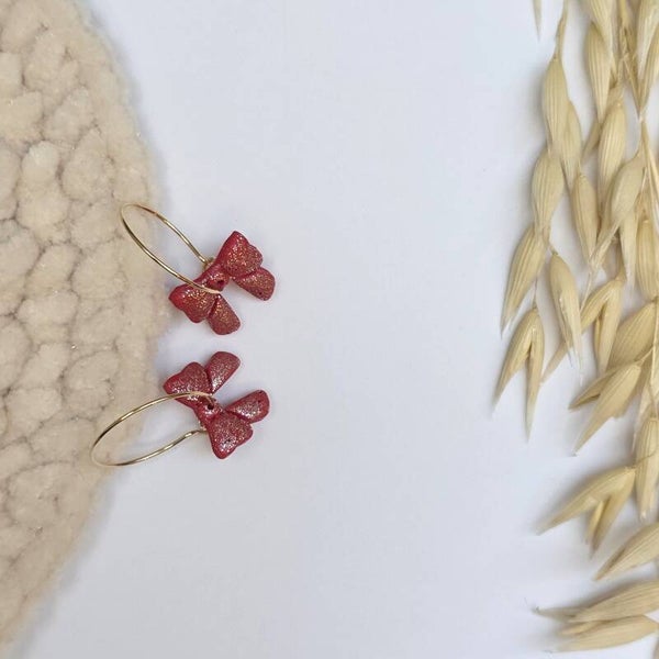 rode glitterstrikjes aan gouden oorringen, kerst.