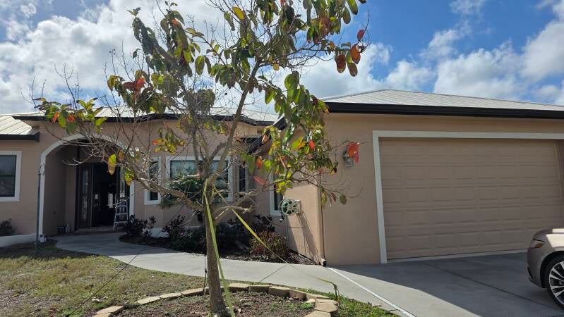 After driveway view Before exterior repaint Port Charlotte Florida home by Integrity Painting