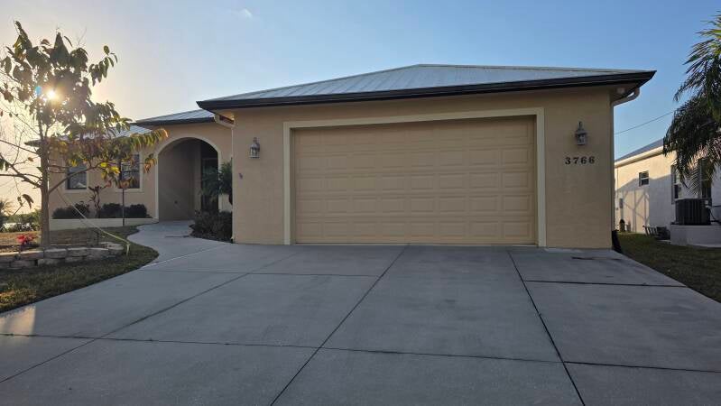 Before driveway view Before exterior repaint Port Charlotte Florida home by Integrity Painting