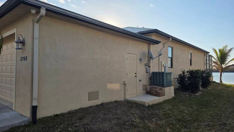 Before Fresh exterior repaint Punta Gorda Florida home by Integrity Painting