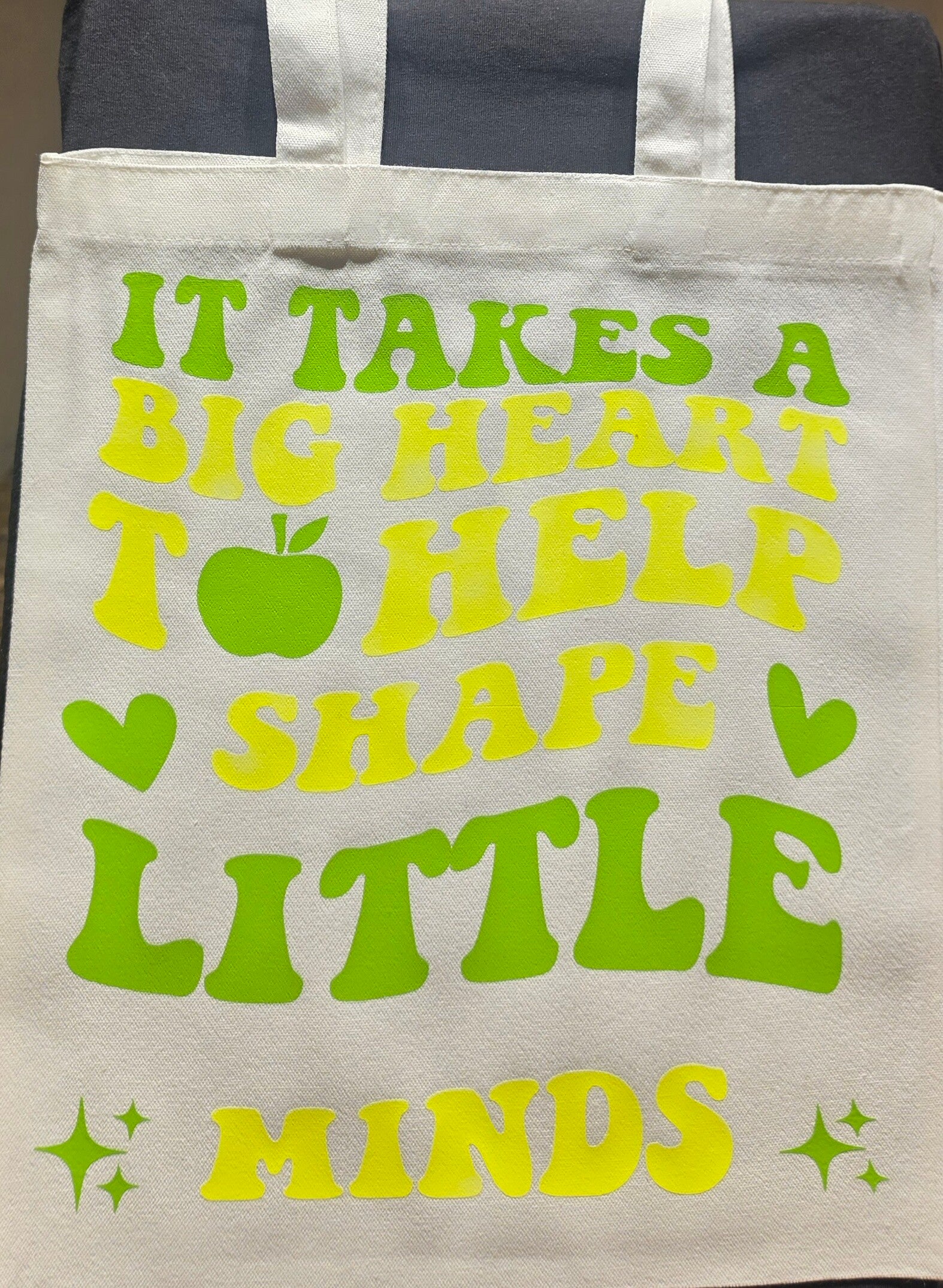 "IT TAKES A BIG HEART TO HELP SHAPE LITTLE MINDS" TOTE BAG