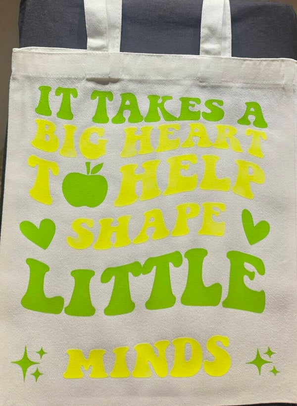 "IT TAKES A BIG HEART TO HELP SHAPE LITTLE MINDS" TOTE BAG
