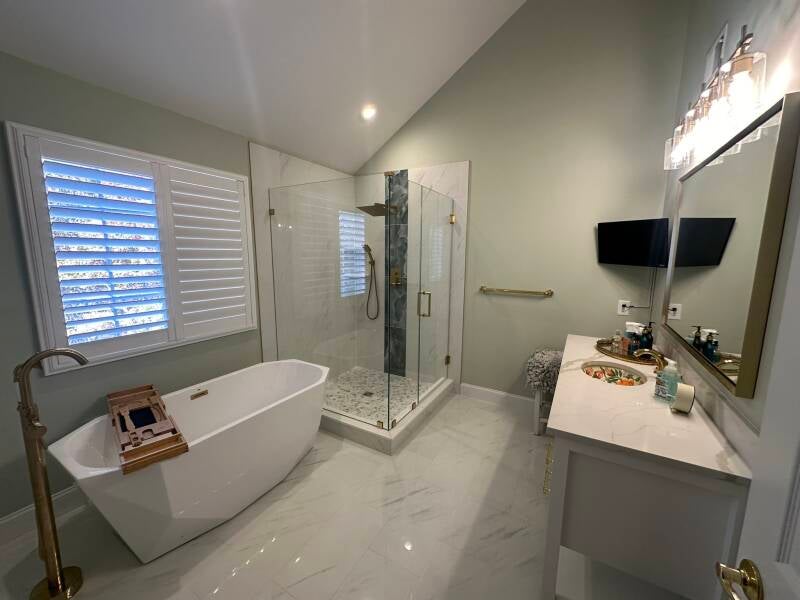 Luxury primary bathroom remodel with freestanding tub, glass shower and marble-look tile in Monmouth County NJ