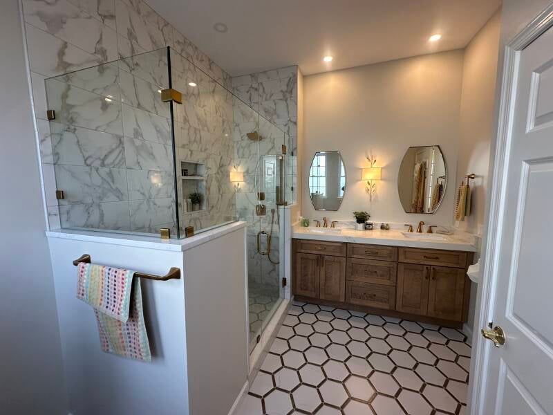 Custom bathroom renovation with marble-look shower tile, wood vanity and patterned floor in Monmouth County NJ