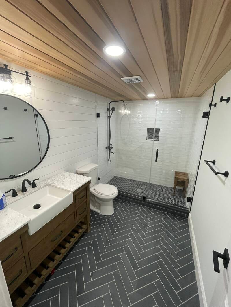 Custom bathroom renovation with wood ceiling, herringbone flooring and large walk-in shower in Monmouth County NJ