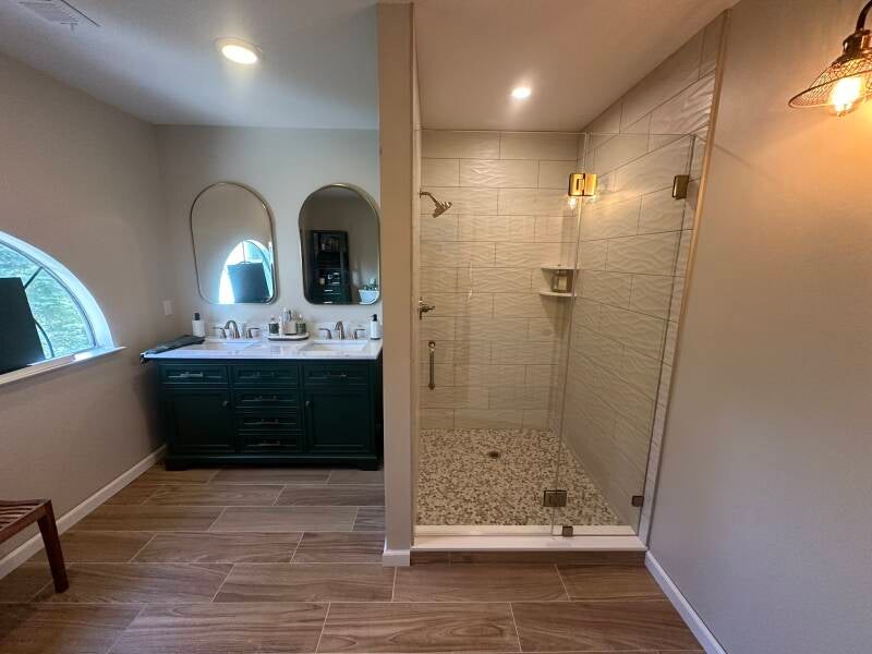 Bathroom renovation with double vanity, wood-look flooring and custom tiled shower in Monmouth County NJ