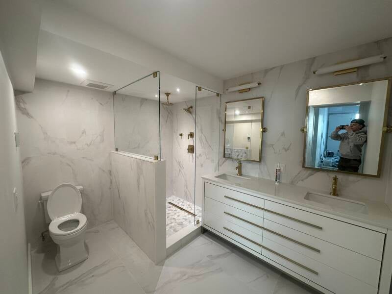 Modern bathroom renovation with floating-style vanity, large-format tile and custom glass shower in Monmouth County NJ