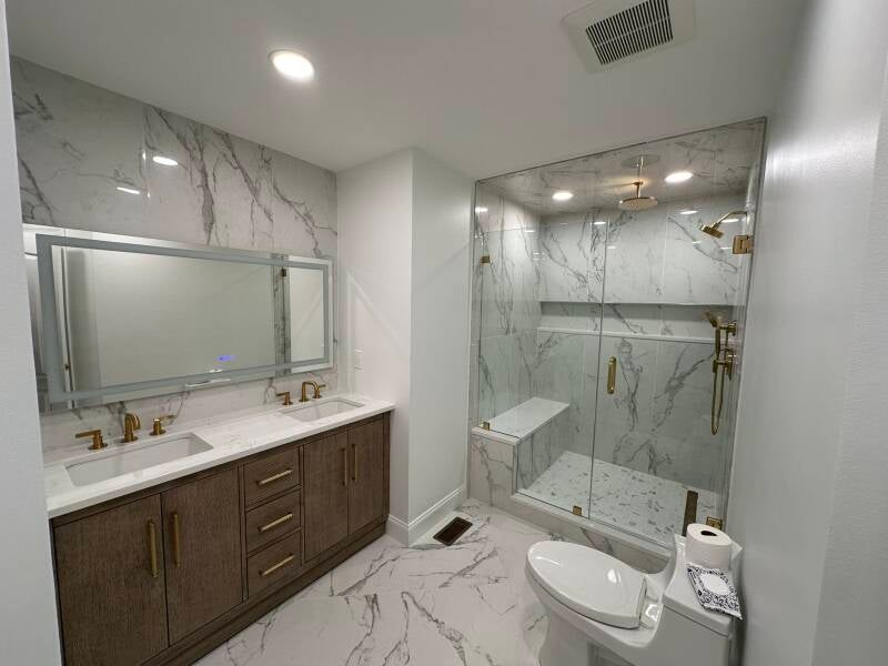 Modern bathroom remodel with double vanity, large-format tile and frameless glass shower in Monmouth County NJ
