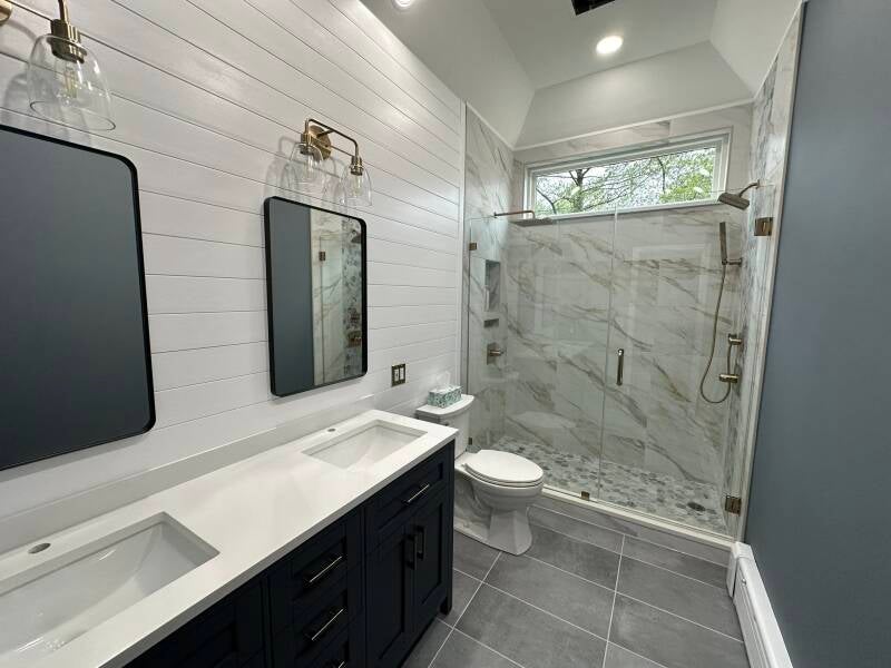 Bright bathroom remodel with double vanity, white tile walls and large custom shower in Monmouth County NJ