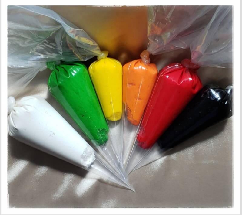 Jean Dough in piping bags (from left to right white,green,yellow,orange,red,black)