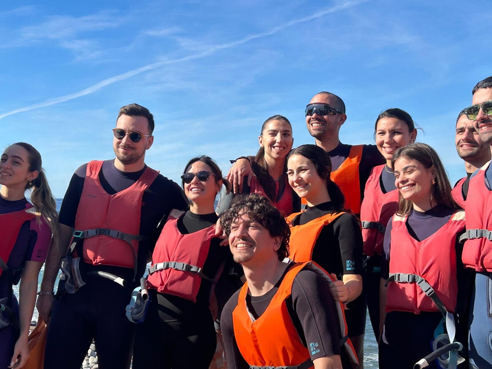 Group of happy young people leaving Palya Arenita for the kayak excursion.