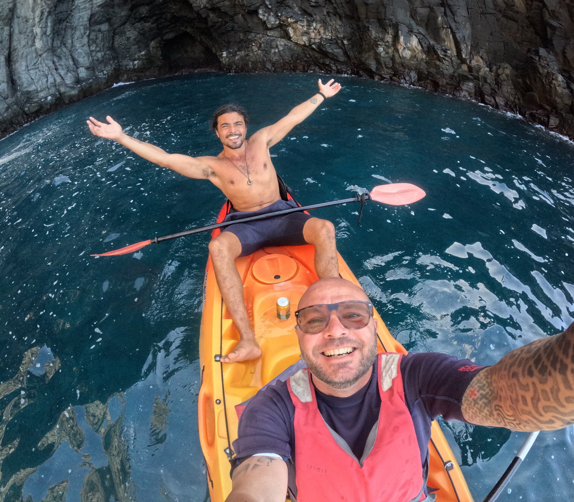 Happy customers on a hike with the pink cave of Palm Mar behind them