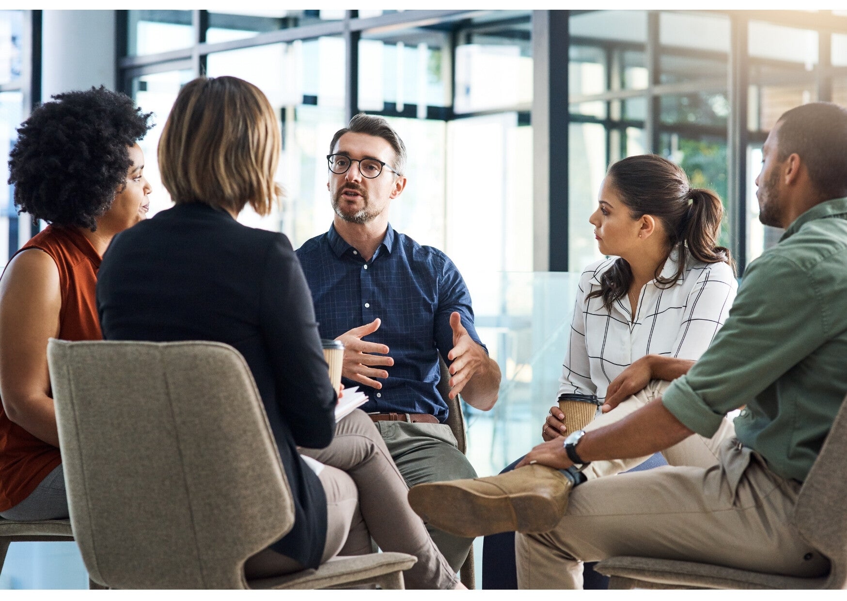 Small group seated together in conversation during a business meeting.