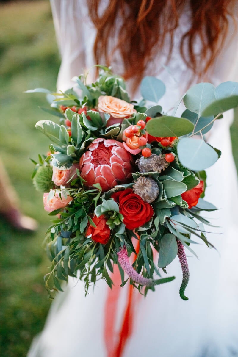 red-haired-bride-holds-perfect-wedding-bouquet-made-red-standard.jpg