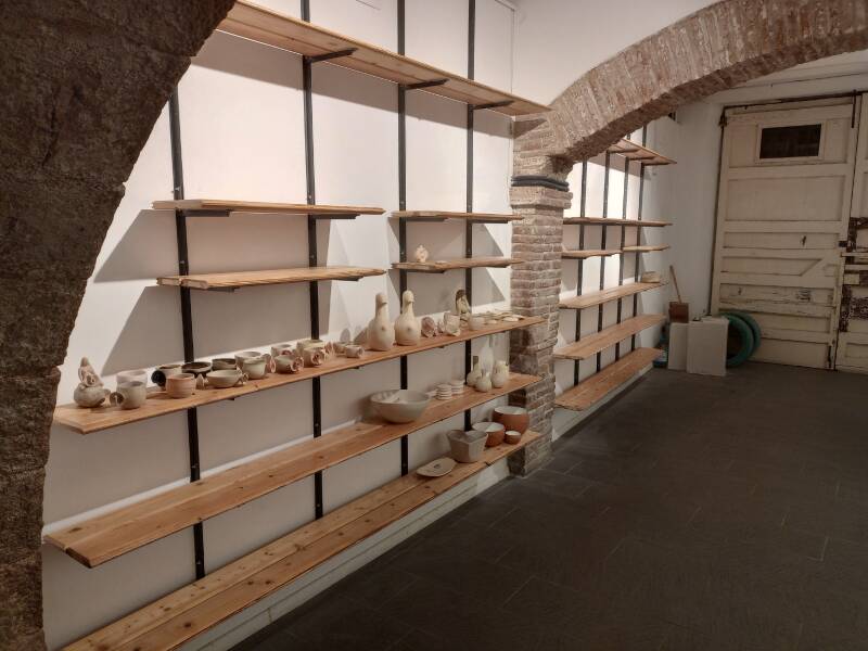 Pottery studio with bespoke shelving using re-purposed wood and a custom made black steel adjustable shelf system
