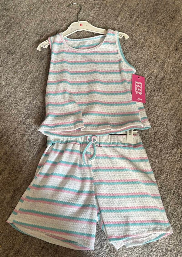 Girls pink white and blue shorts and vest top.