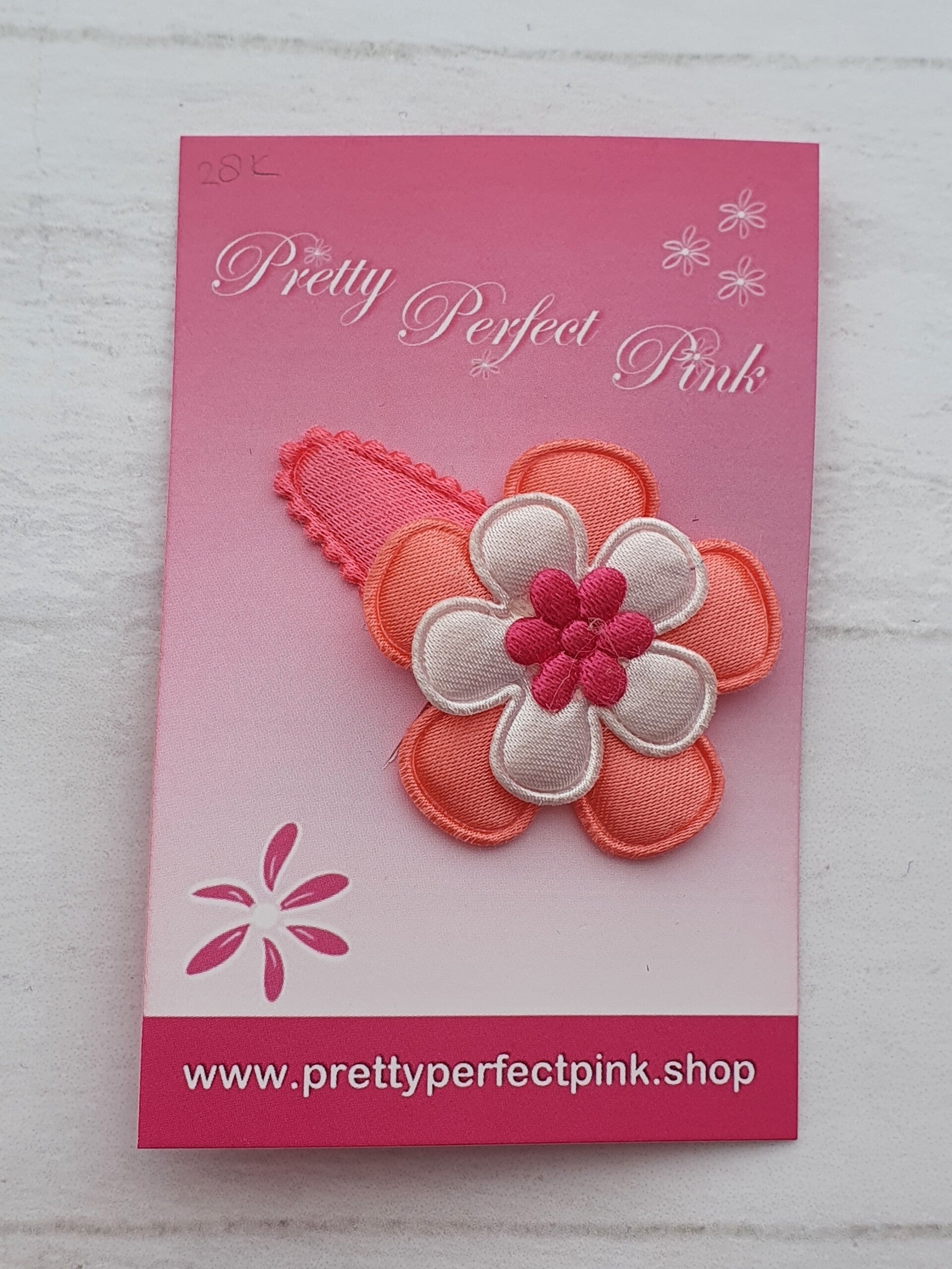 Neon roze haarspeldje met bloemetjes